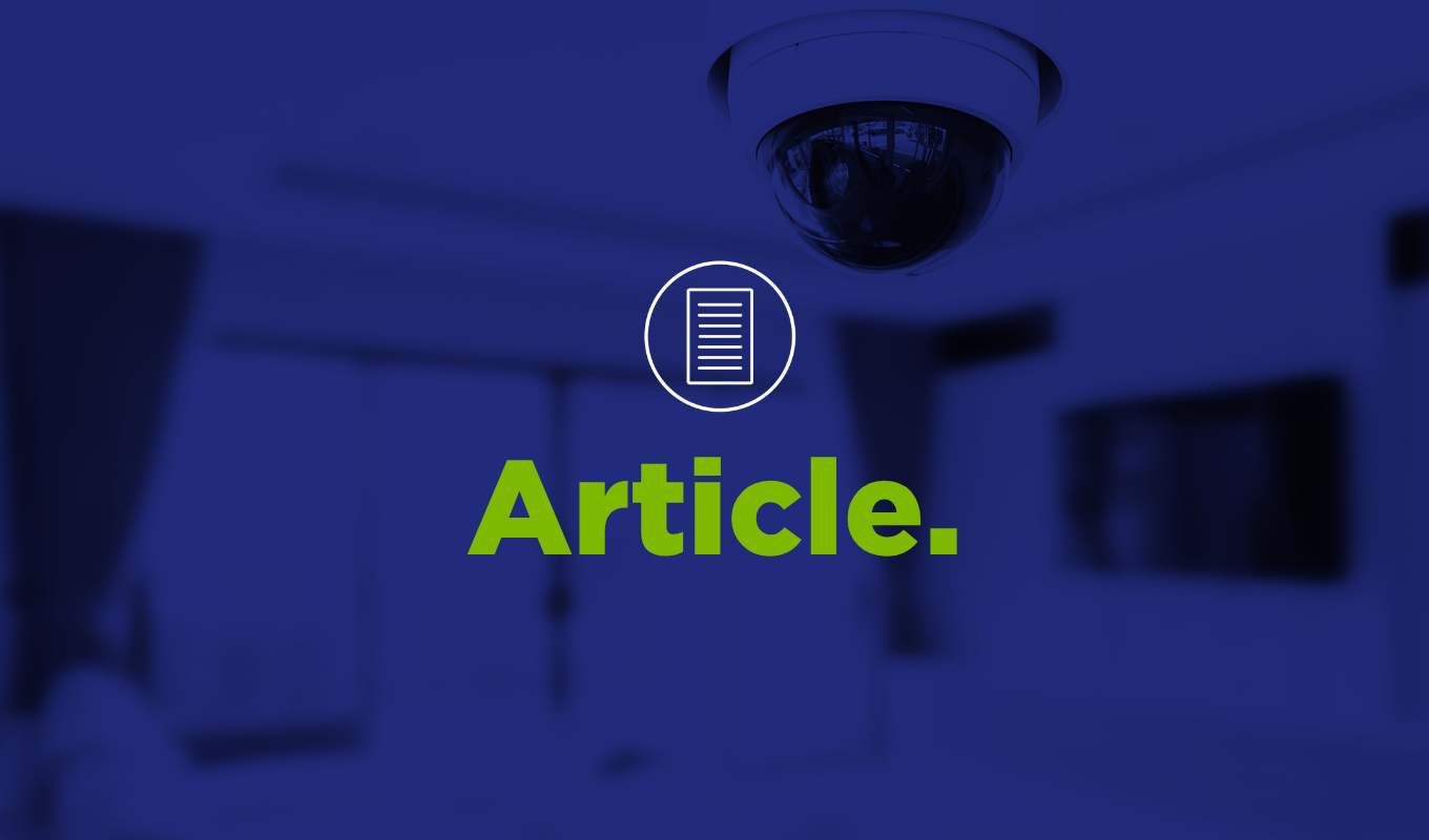 Indoor scene showing a dome‑style surveillance camera mounted on a ceiling in a modern room, with blurred office furniture in the background and an overlaid document icon and the word “Article.”