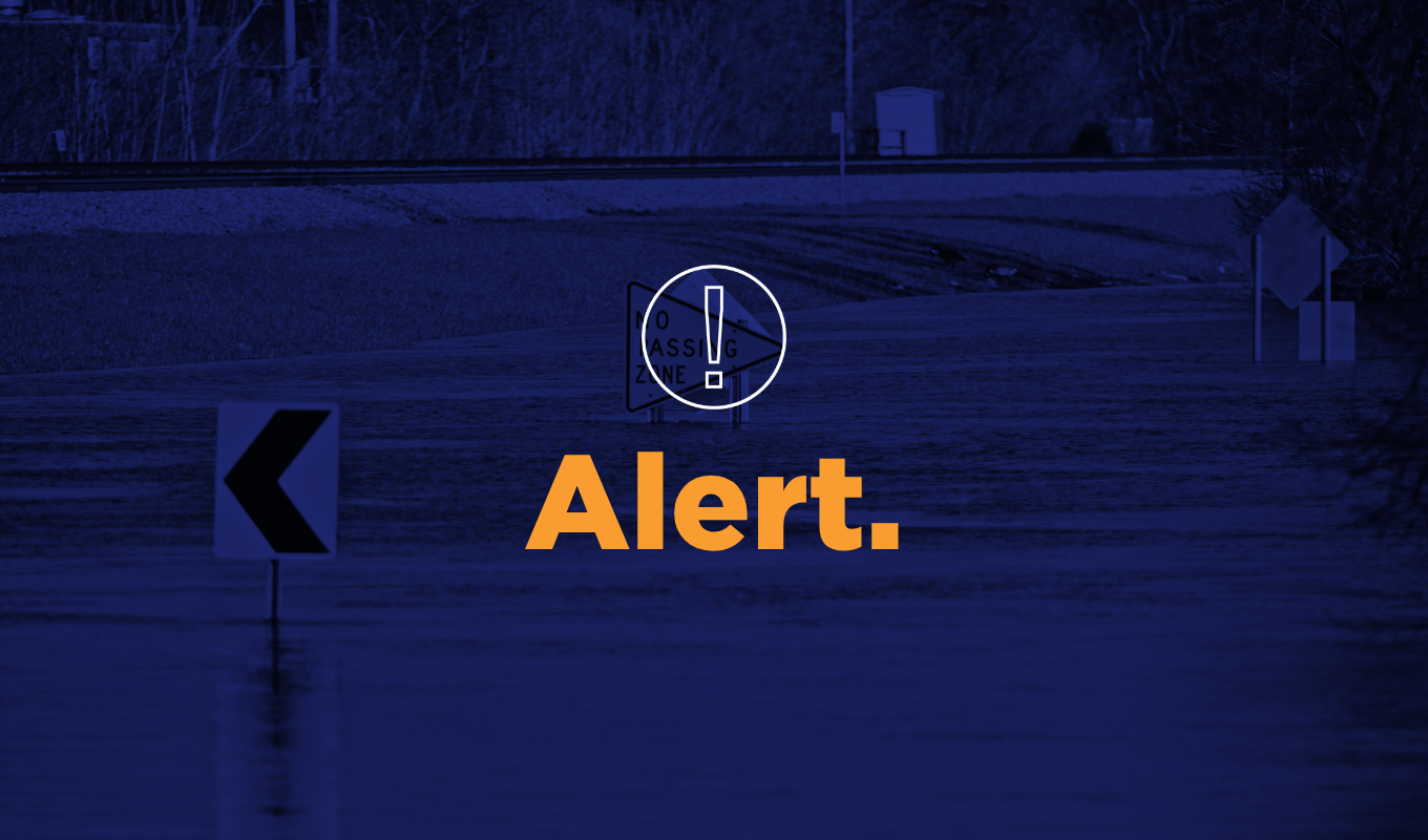 alert thumbnail showing a flooded roadway with traffic signs partially submerged in water.